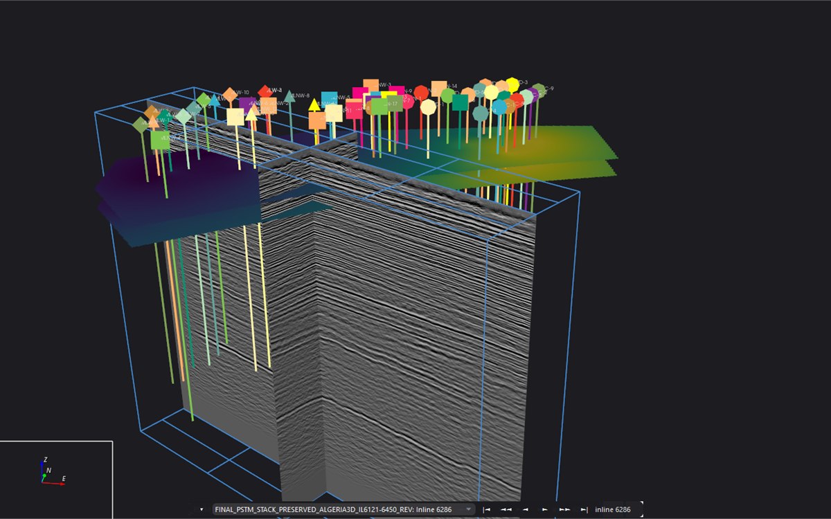 Geo-Base 3D view: a seismic volume shown as two intersecting sections inside a survey box, with coloured well paths hanging from posted well markers and two interpreted surfaces.